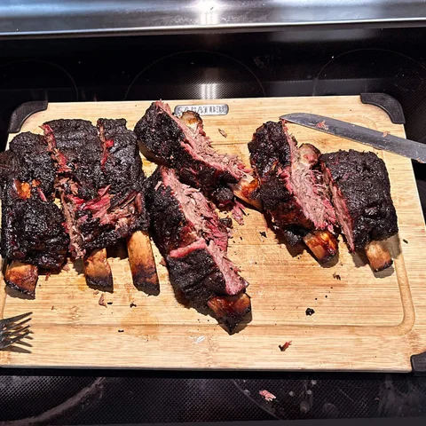 Smoked beef ribs on a cutting board