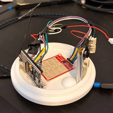 ESP32 sensor PCB wired up on a workbench